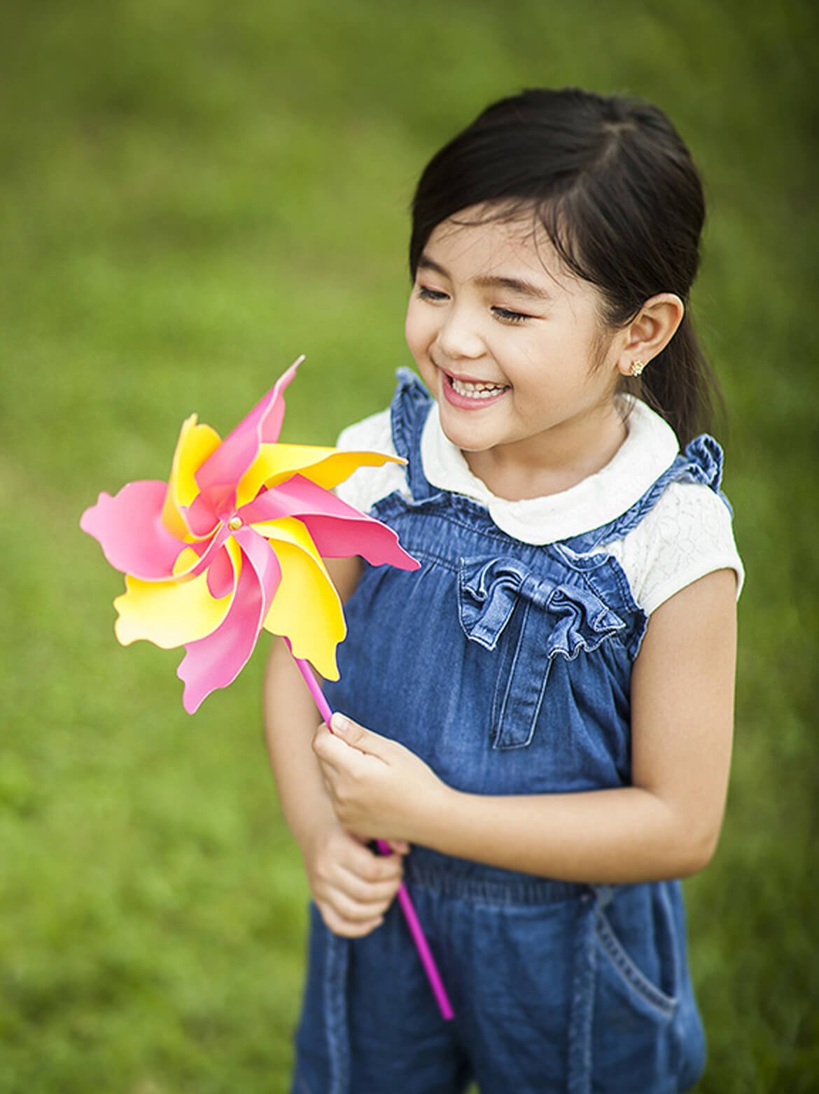 Child playing in open green neighborhood spaces